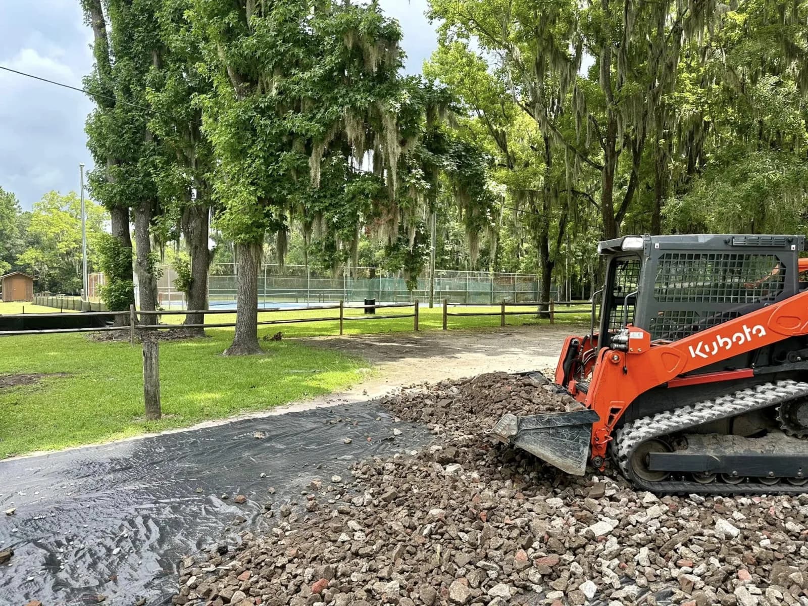 Down East compact track loader placing aggregate during a real site-preparation project